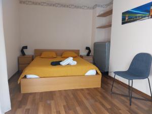 ロデーズにあるLe Bullière 60m2 plein centre!のベッドルーム1室(ベッド1台、椅子付)