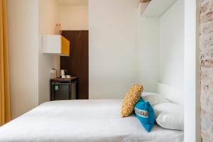 a bed with two pillows on top of it at Guoda Apartments in Vilnius