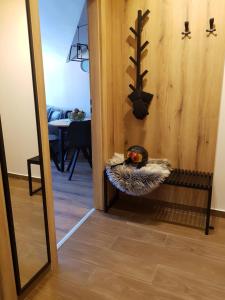 a mirror in a hallway with a bird sitting on a shelf at PinePino Borovets, aparthotel Borovets Gardens A60 in Borovets