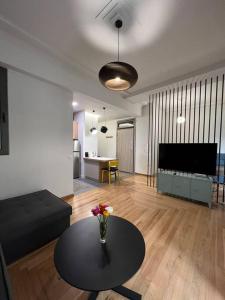 a living room with a vase of flowers on a table at Athens Special in Athens