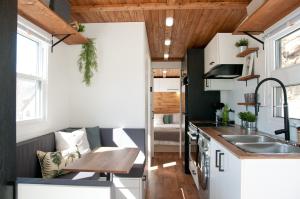 a tiny kitchen with a table and a sink at Chalets Didoche in Havre-Saint-Pierre