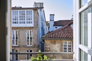a view from a window of buildings at Hostal Suso in Santiago de Compostela