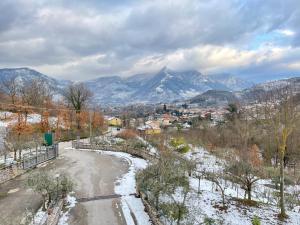 a snowy road with mountains in the background at B&B Da Felice in Serino