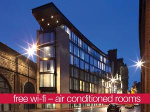 an office building with the words free wi fi air conditioned rooms at Sleeperz Hotel Newcastle in Newcastle upon Tyne