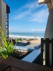 a view of the beach from the balcony of a condo at Studio 2 pers avec vue sur l'océan in Lacanau