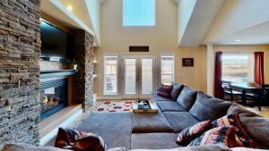 a living room with a couch and a fireplace at Moab Desert Home in Moab
