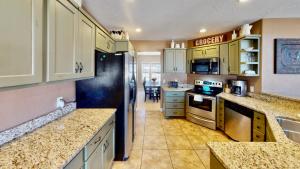a kitchen with yellow cabinets and a counter top at Moab Desert Home in Moab