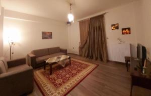 a living room with a couch and a table at Helen's House in Tríkala