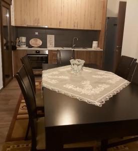a kitchen with a table with a white table cloth at Helen's House in Tríkala