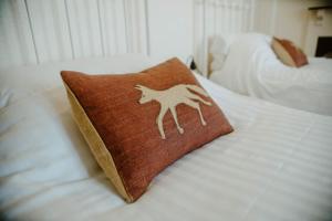 a brown pillow with a horse on a bed at Toghill House Farm in Wick