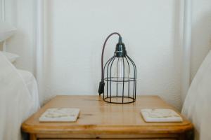 a bird cage sitting on a wooden table at Toghill House Farm in Wick