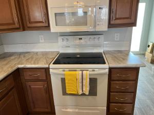 a kitchen with a stove and a microwave at Monte Vista Village Resort Mesa 3 Bed 2 Bath Age 55 Plus Community in Mesa