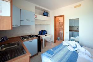 a small kitchen with a sink and a stove at Pensione La Torretta in Peschici +18 photos