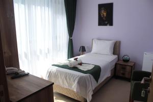 Postel nebo postele na pokoji v ubytování Garden terrace otel