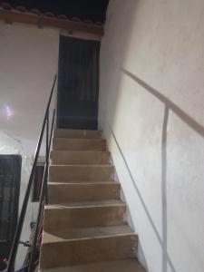 un escalier menant à une porte dans un bâtiment dans l'établissement Habitación rústica independiente con todas las comodidades y sofacama, à Tordesillas