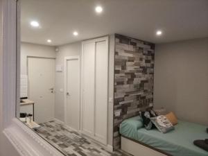 a bedroom with a brick accent wall and a bed at RANDMAR APARTMENT COSTA DEL SOL in Benalmádena