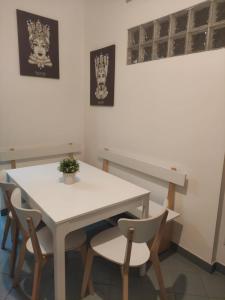 a white table and chairs in a room at Franchetti House in Catania