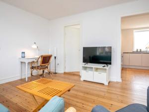 a living room with a television and a table at Holiday home Esbjerg V XX in Esbjerg