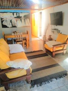 a living room with two couches and a tv at Alojamiento Santino, en Cataratas del Iguazu in Puerto Iguazú