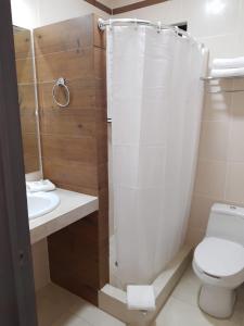 a bathroom with a shower and a toilet and a sink at H Rooms Hoteles Inn in La Piedad Cavadas +7 photos