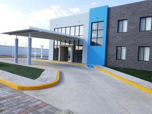 a large building with a blue and white at H Rooms Hoteles Inn in La Piedad Cavadas
