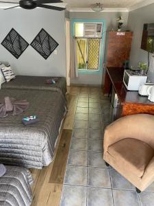a room with two beds and a table and a window at Limassol Motel in Gold Coast