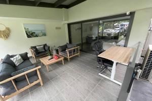 a living room with a couch and a table at Quiet private getaway, private gym walk 2 beach in Terrigal
