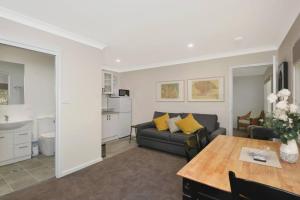 a living room with a couch and a table at Sur Le Mont - Blackheath - Studio Apartment in Blackheath