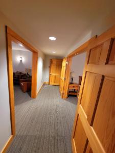 a hallway with a door open to a living room at Minnewaska Lodge in Gardiner
