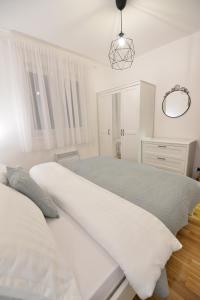 Ένα ή περισσότερα κρεβάτια σε δωμάτιο στο Apartman LUMI