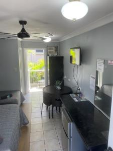 a room with a kitchen and a living room with a table at Limassol Motel in Gold Coast
