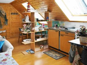 a kitchen with wooden walls and a kitchen with a stove at 6 person holiday home in ASKER N in Stenungsund