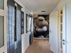 a hallway with a painting on the wall at 11 person holiday home in S LVESBORG in Hällevik