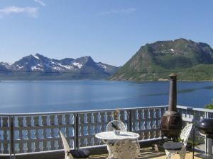 a patio with a view of a lake and mountains at 10 person holiday home in Kaldfarnes in Sifjord