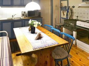 a kitchen with a wooden table with flowers on it at 6 person holiday home in Vittsj in Ubbalt
