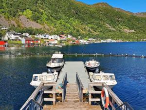 two boats are docked at a dock on a lake at 10 person holiday home in Kaldfarnes in Sifjord