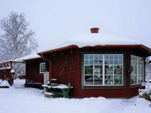 a small red house with snow on the roof at 6 person holiday home in BODAFORS in Västrahyn