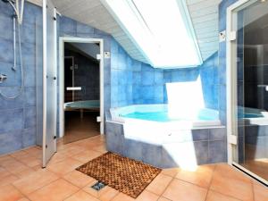 a bathroom with a tub and a shower at 12 person holiday home in Otterndorf in Otterndorf