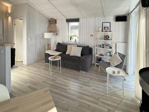 a living room with a couch and a table and chairs at 4 person holiday home in GROEMITZ in Grömitz