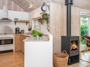 a kitchen with a wood stove in the middle at 6 person holiday home in Hemmet in Hemmet