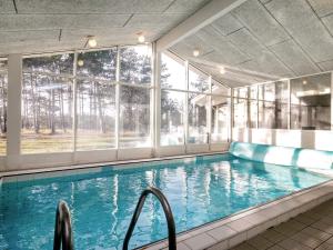 a large swimming pool with a large window at Six-Bedroom Holiday home in Humble in Humble