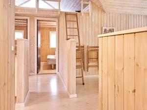 a wooden room with wooden walls and a wooden floor at 6 person holiday home in Aakirkeby in Vester Sømarken