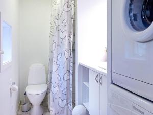 a bathroom with a toilet and a washing machine at 6 person holiday home in Aakirkeby in Vester Sømarken