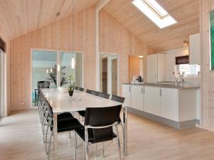 a kitchen and dining room with a table and chairs at 16 person holiday home in Tisvildeleje in Tisvildeleje