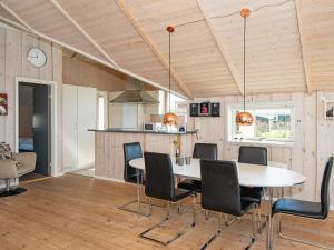 a kitchen and dining room with a table and chairs at 6 person holiday home in Hemmet in Falen