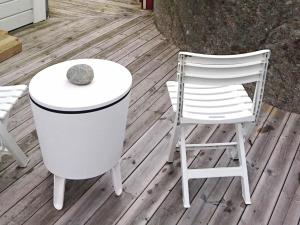 a white table and a chair on a deck at 2 person holiday home in R nn ng in Rönnäng
