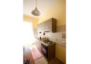 a kitchen with yellow walls and a stove top oven at Sophie's Choice in Rome