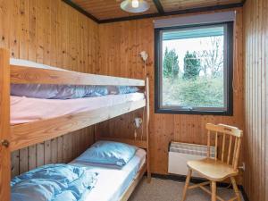 a bedroom with two bunk beds and a window at Three-Bedroom Holiday home in Toftlund 6 in Vestergård
