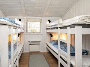 a bedroom with two bunk beds in a house at 10 person holiday home in Humble-By Traum in Humble
