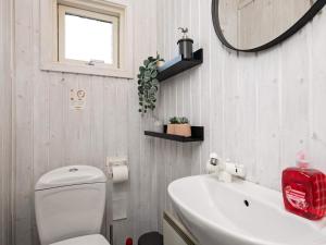 a bathroom with a toilet and a sink and a mirror at 10 person holiday home in Humble-By Traum in Humble +32 photos